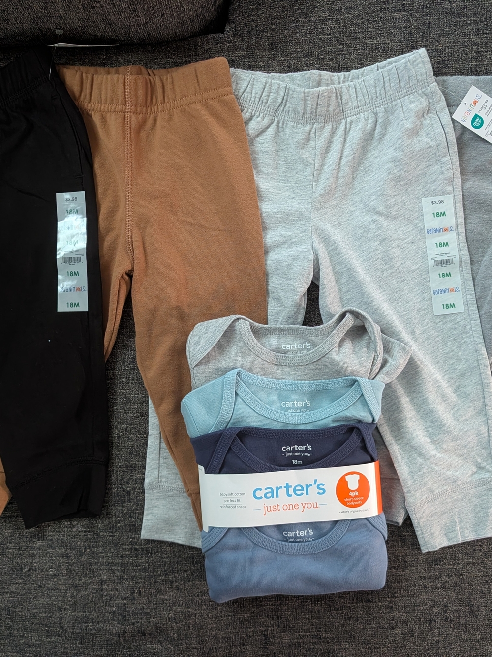 4 Carter's Onesies And 4 Garanimals Pants in Black, Brown, and Light Blue